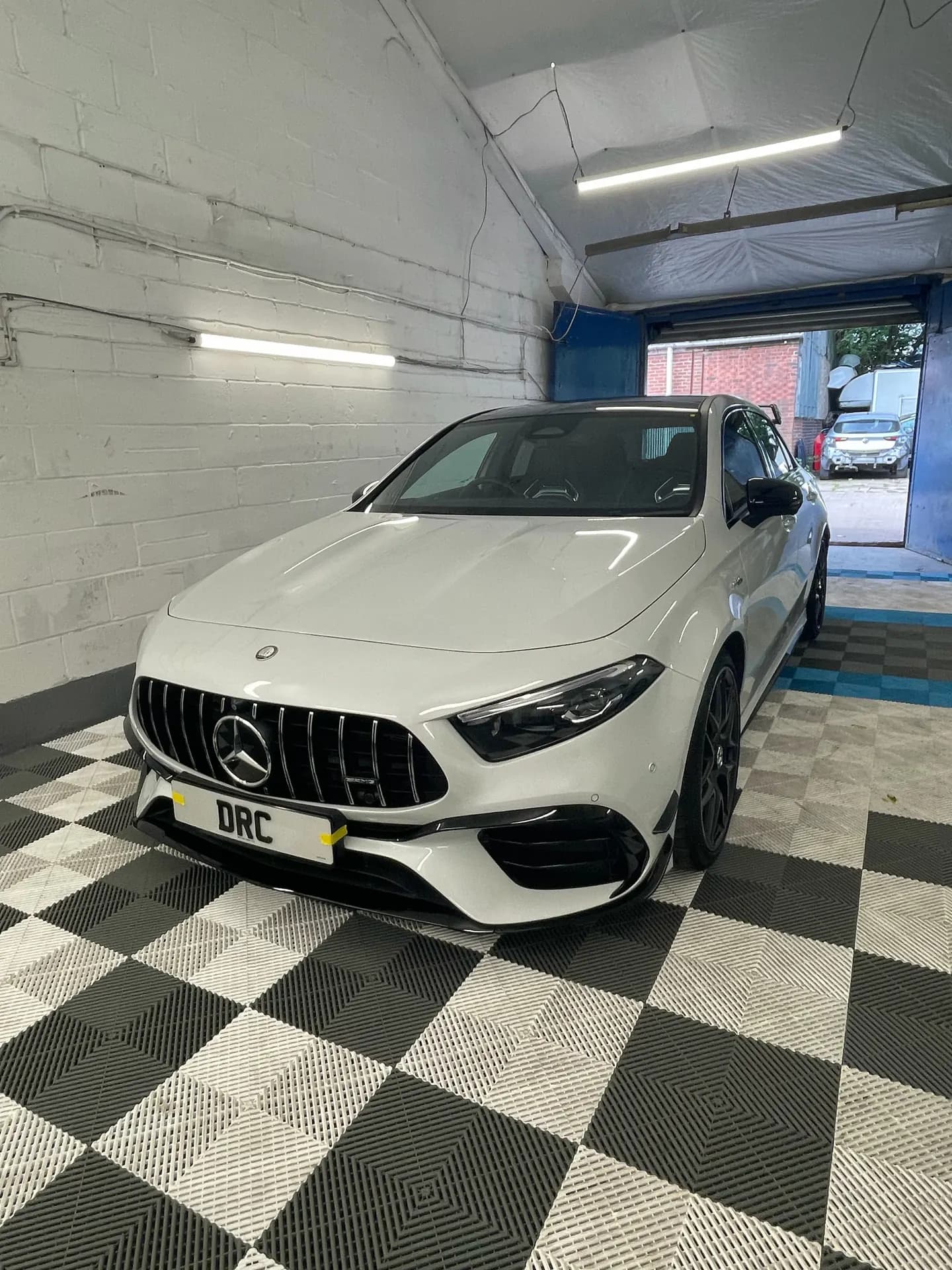 White Mercedes-AMG A45 after detailing by DRC Car Care, in the DRC Car Care unit
