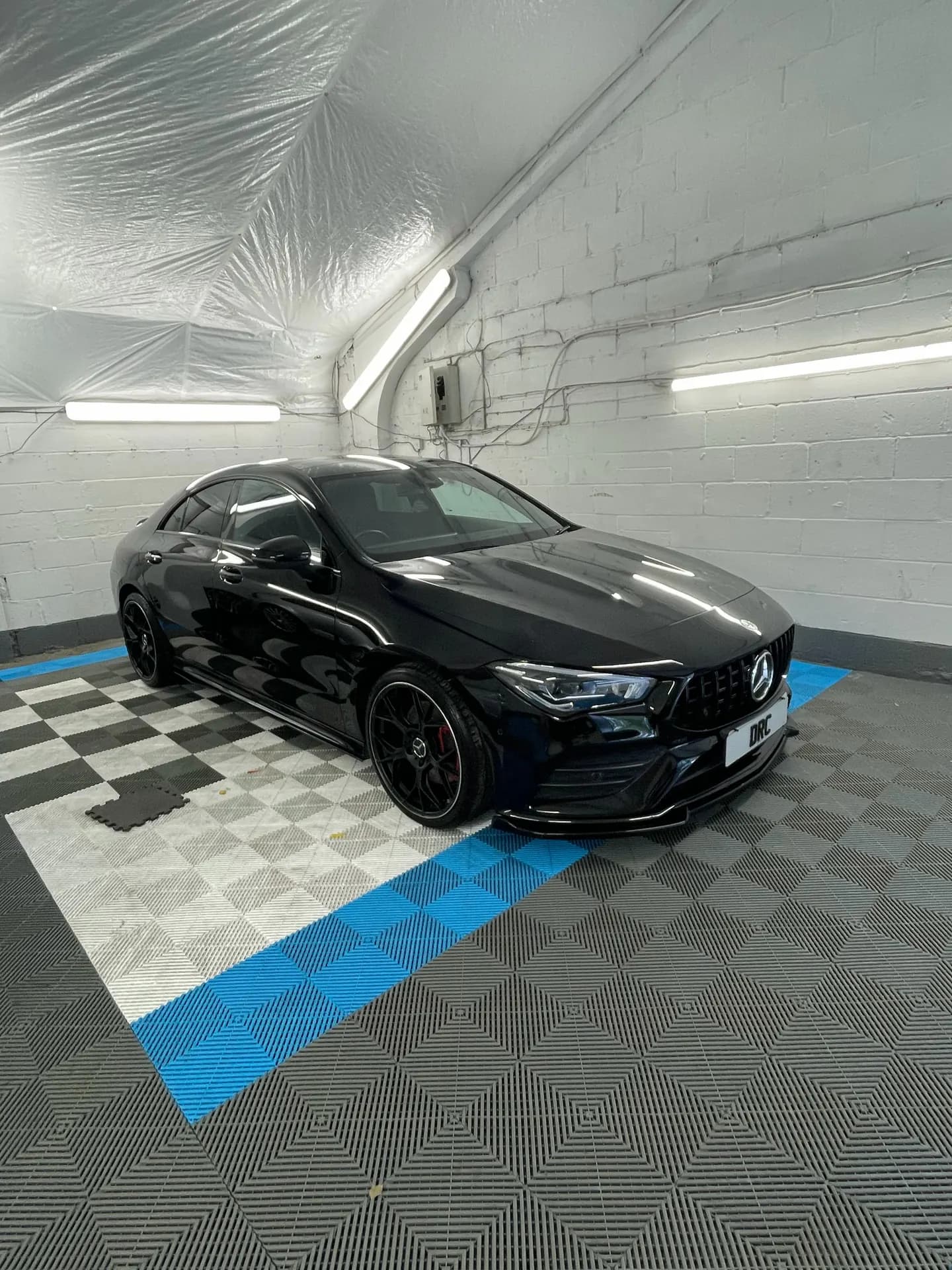 Black Mercedes-AMG CLA after detailing by DRC Car Care, in the DRC Car Care unit